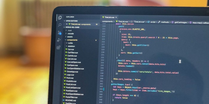 A laptop showing JavaScript code