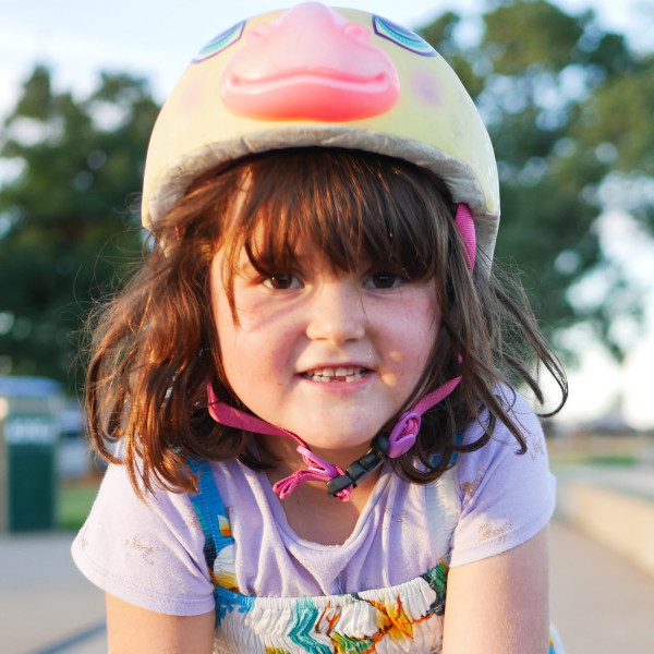 Jessie at the skatepark wearing a helmet.