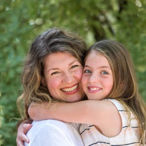 Kate smiling and hugging her daughter.