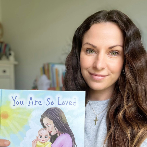 Photo of Samantha Heidrich holding her book You Are So Loved