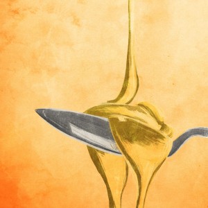 A spoon full of honey overflowing